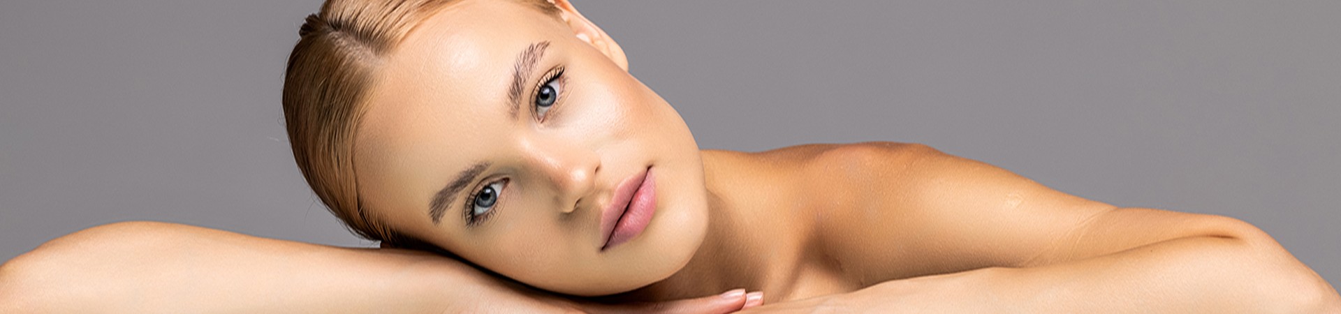 Healthy skin woman beautiful face close up over gray background Healthy skin woman beautiful face close up over gray background