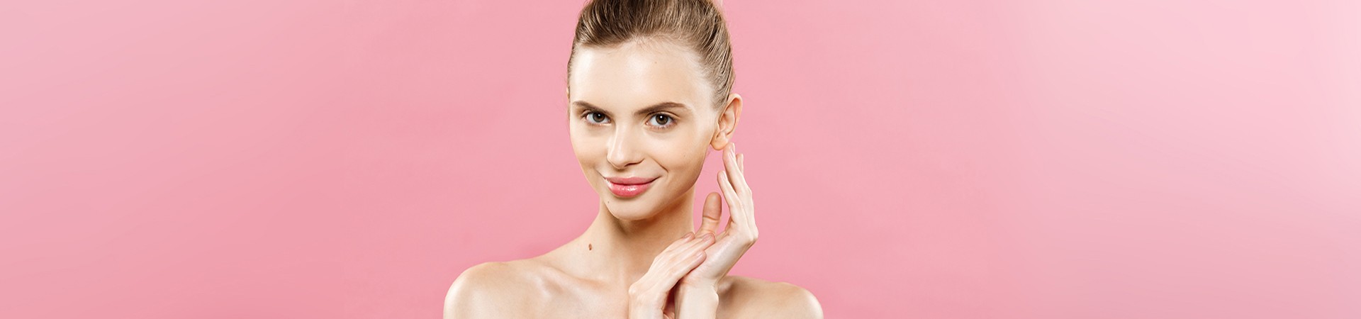 Beauty Concept - Beautiful Caucasian woman with clean skin, natural make-up isolated on bright pink background with copy space.